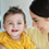 A female caregiver smiles at a little boy